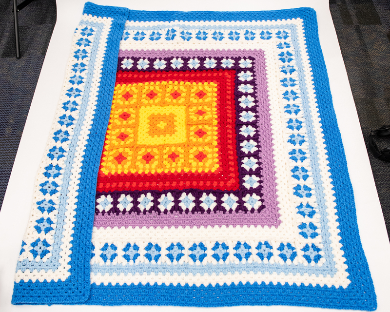 An image of an afghan partially folded.