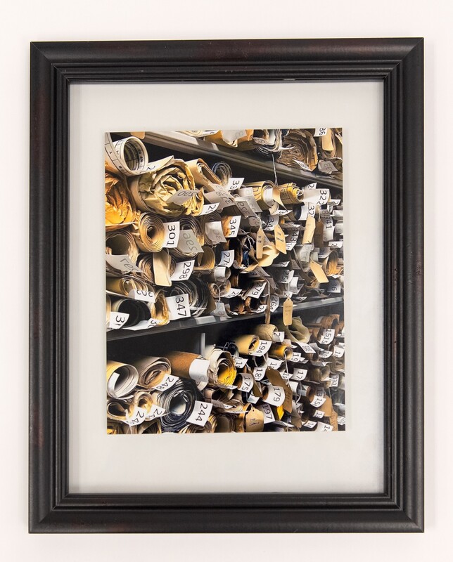 Image of architectural drawings rolled up on a shelf.