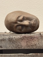 Artist: JinSun Kim. A close up of Series of Urban City 1 - detailing a sculpted clay head resting on top of a metal tower-like structure.