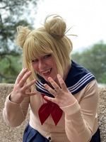 Artist: Phebe Raglin. 10 by 11-inch blond wig. The hairpiece is fashioned with an angled bob cut, straight bangs and small side buns on each side of the head.