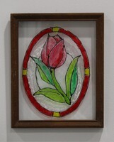 Stained glass panel of a red tulip with green leaves encircled by a red ring.