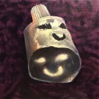 Artist: David Hill. 11 by 11-inch Acrylic on canvas stretched wood panel titled, Sphinx. The top of a tube (with the cap on) rests of a bed of purple yarn. The tube has been cut and emptied, with eyes and a smiling mouth cut out of the tube. The perspective allows light to shine through the tube surface and reflect on the inside of the tube.