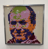 Artist: Ruby Mehrubeoglu. 16 by 16-inch framed Lego piece. Lego 1x1 plate round dots attached to a background plate, the dots are arranged to create a portrait.
