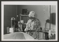 A woman doctor working on a patient.