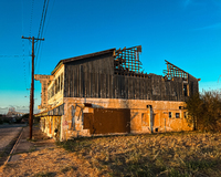 color photograph of an old building with a bridge in the distance