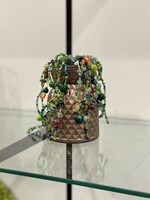 Artist: Brittani Fletcher. 6 by 3-inch mixed media titled Plantalina. A metallic painted faceted vase with moss and beaded plant-like tendrils.