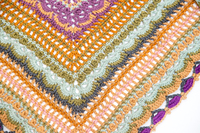 Close up of colorful crocheted shawl.
