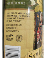 Label of a vanilla extract product from Mexico, featuring text about its flavor, ingredients, and certification logos.

Transcribed Text:
PRODUCT OF MEXICO
THE USED OF VANILLA BEEN GUARANTIES THE DELICATE AROMA AND FLAVOR OF OUR PRODUCT
DOES NOT CONTAIN CUMARIN OR CONSERVATIVES
MX
HECHO EN MÉXICO
KOSHER PAREVE
[barcode] 6000333.9