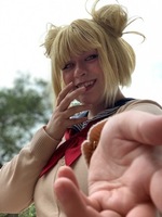Artist: Phebe Raglin. 10 by 11-inch blond wig. The hairpiece is fashioned with an angled bob cut, straight bangs and small side buns on each side of the head.