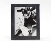 Black dog holding a stick.