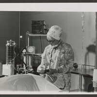 A woman doctor working on a patient.