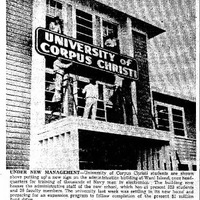Students putting up the new university sign in the administration building