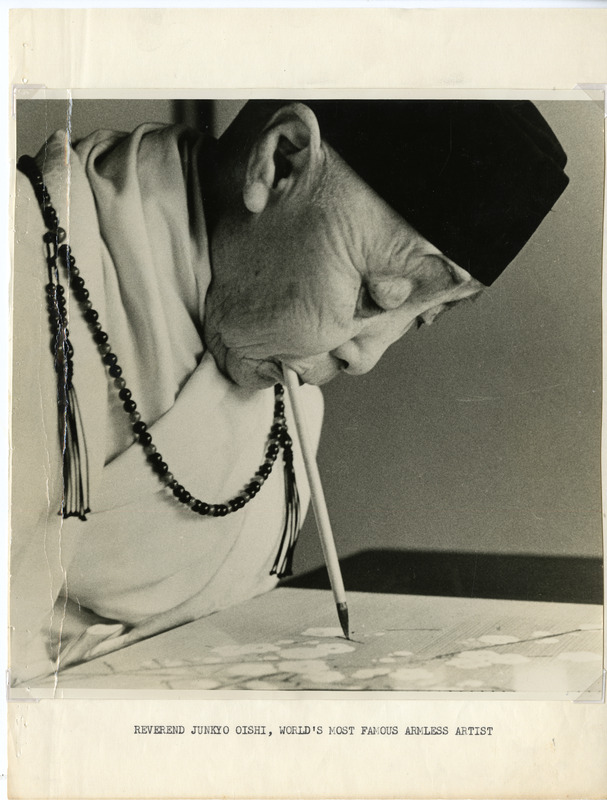 Elderly person painting with a brush held in their mouth, wearing traditional robes and a beaded necklace.
Text Section: "REVEREND JUNKO OISHI, WORLD'S MOST FAMOUS ARMLESS ARTIST"