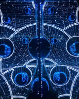 Illuminated blue and white circular decorations with a complex, symmetrical design.