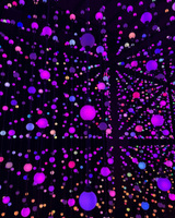 A display of multicolored, spherical lights hanging in a dark room.