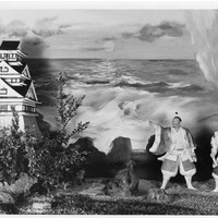 Diorama of a Japanese castle by the sea with two figures in traditional attire.