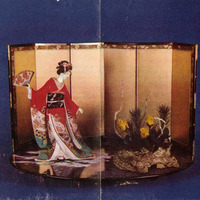 Traditional Japanese screen (byōbu) with a figurine in a red kimono and a floral arrangement.