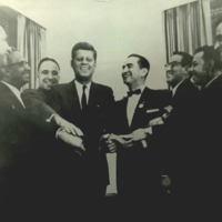 Photograph of John F. Kennedy with Viva Kennedy club leaders.