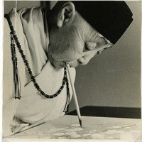 Elderly person painting with a brush held in their mouth, wearing traditional robes and a beaded necklace.

Text Section: "REVEREND JUNKO OISHI, WORLD'S MOST FAMOUS ARMLESS ARTIST"