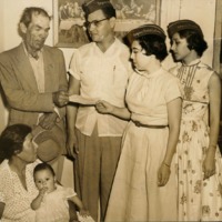 Photograph of AGIF members presenting a check to Guadalupe Vera and his family to support the poor.