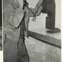 A photograph of a student using the Telephone in Miller Hall from the yearbook TheSilverKing1959.