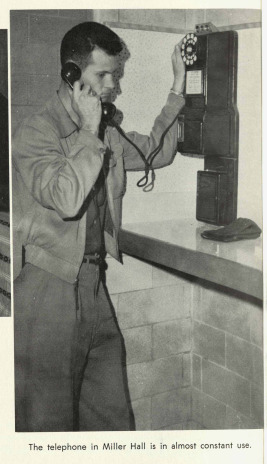A photograph of a student using the Telephone in Miller Hall from the yearbook TheSilverKing1959.