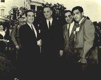 Photograph of Dr. Garcia, President Johnson and AGIF chairmen Augustin Flores and Corky Gonzales posing for a photo in front of the White House. 